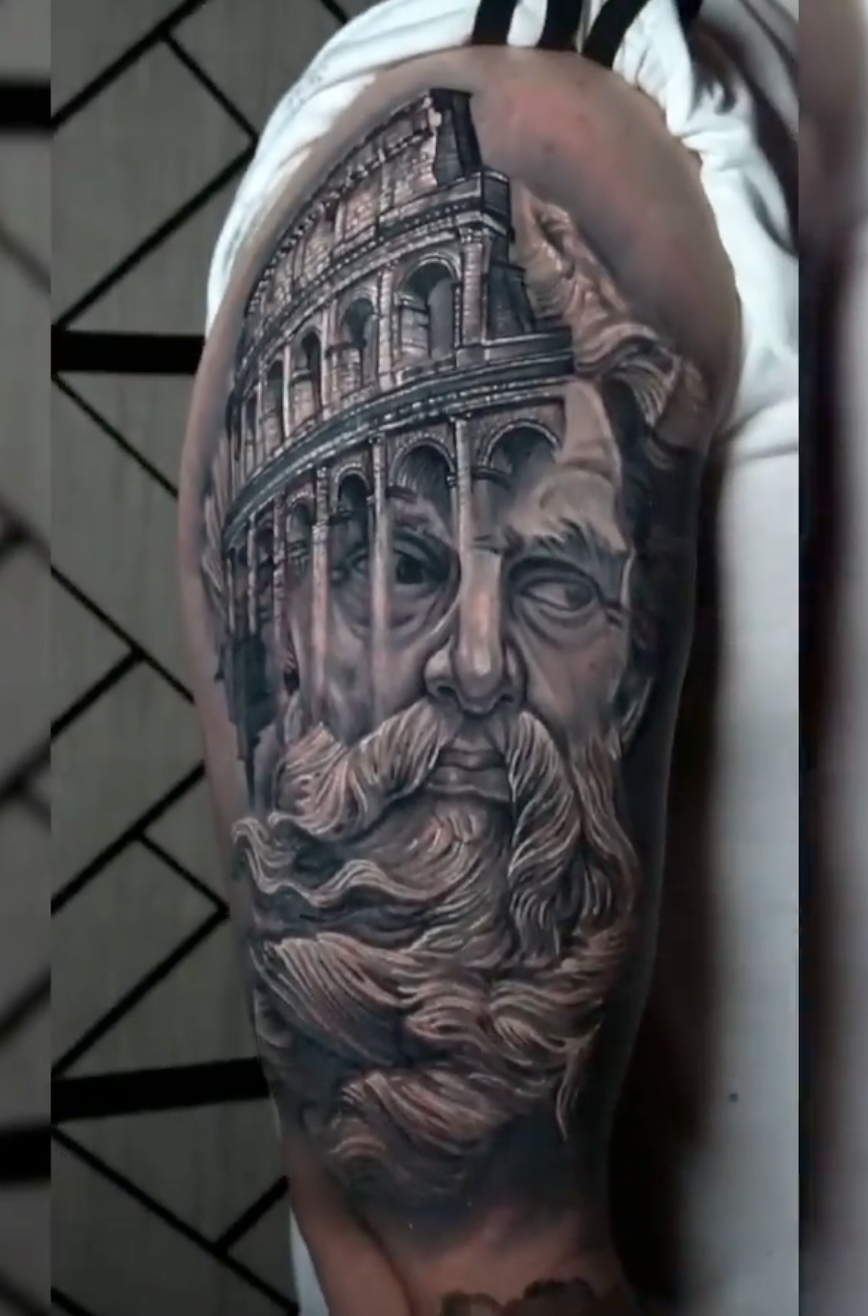 Black-and-grey classical portrait and Colosseum tattoo