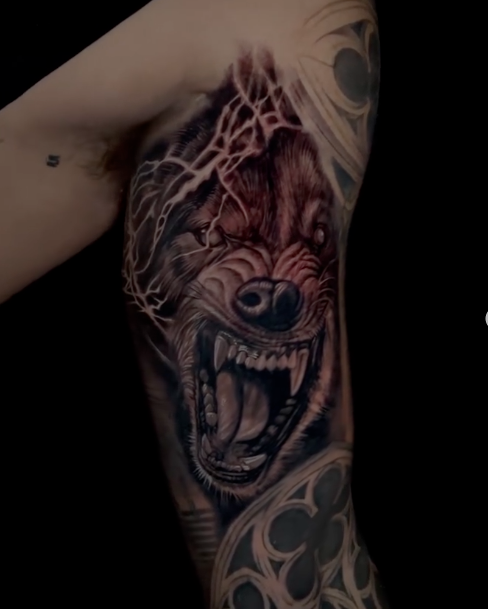 Dark realistic snarling bear tattoo with web details
