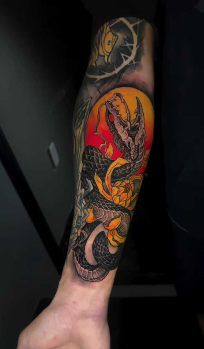 Color black dragon tattoo with an orange sun and flowers